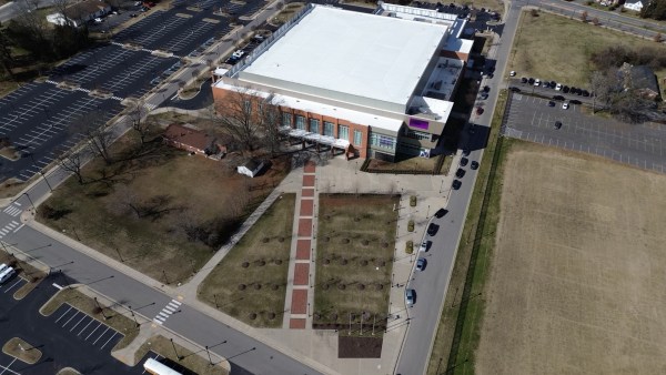 An aerial photograph of the Multipurpose Center at Virginia State University, showing open ground where the battery will be located.